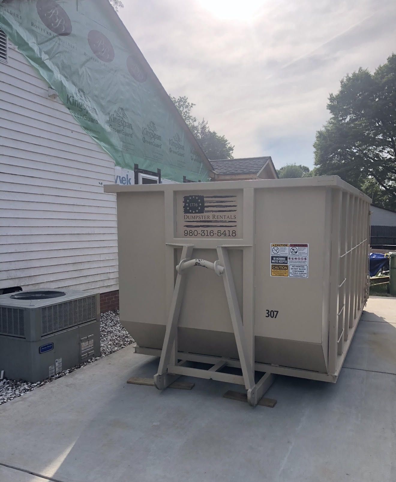 30-yard 1776 dumpster number 307 beside a residential project